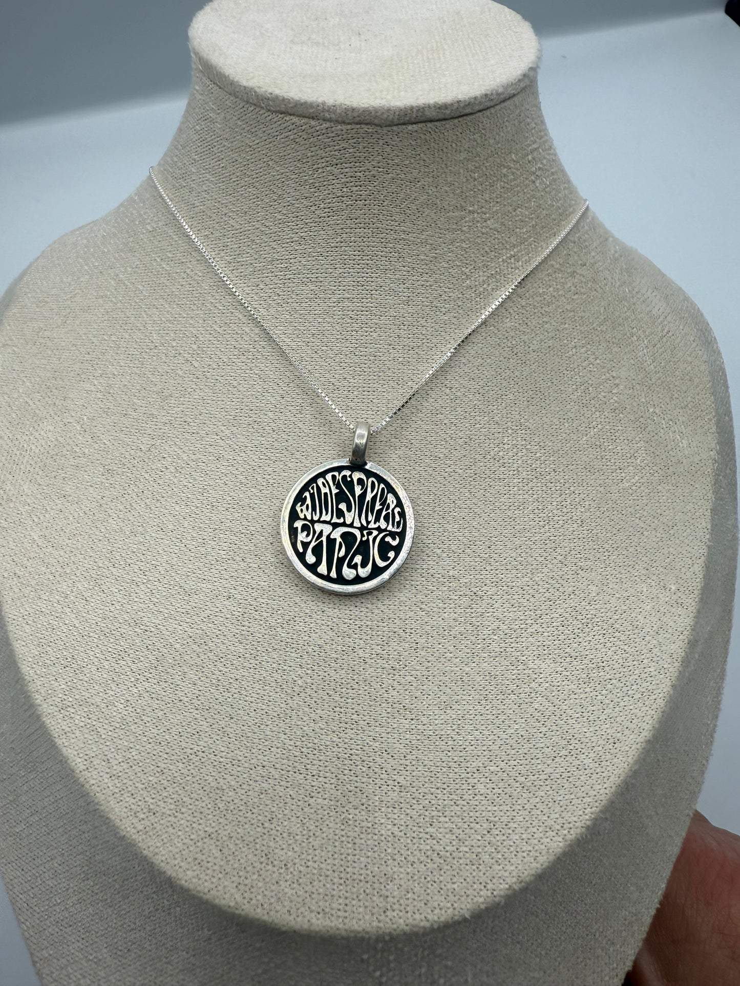 widespread circle logo in sterling silver