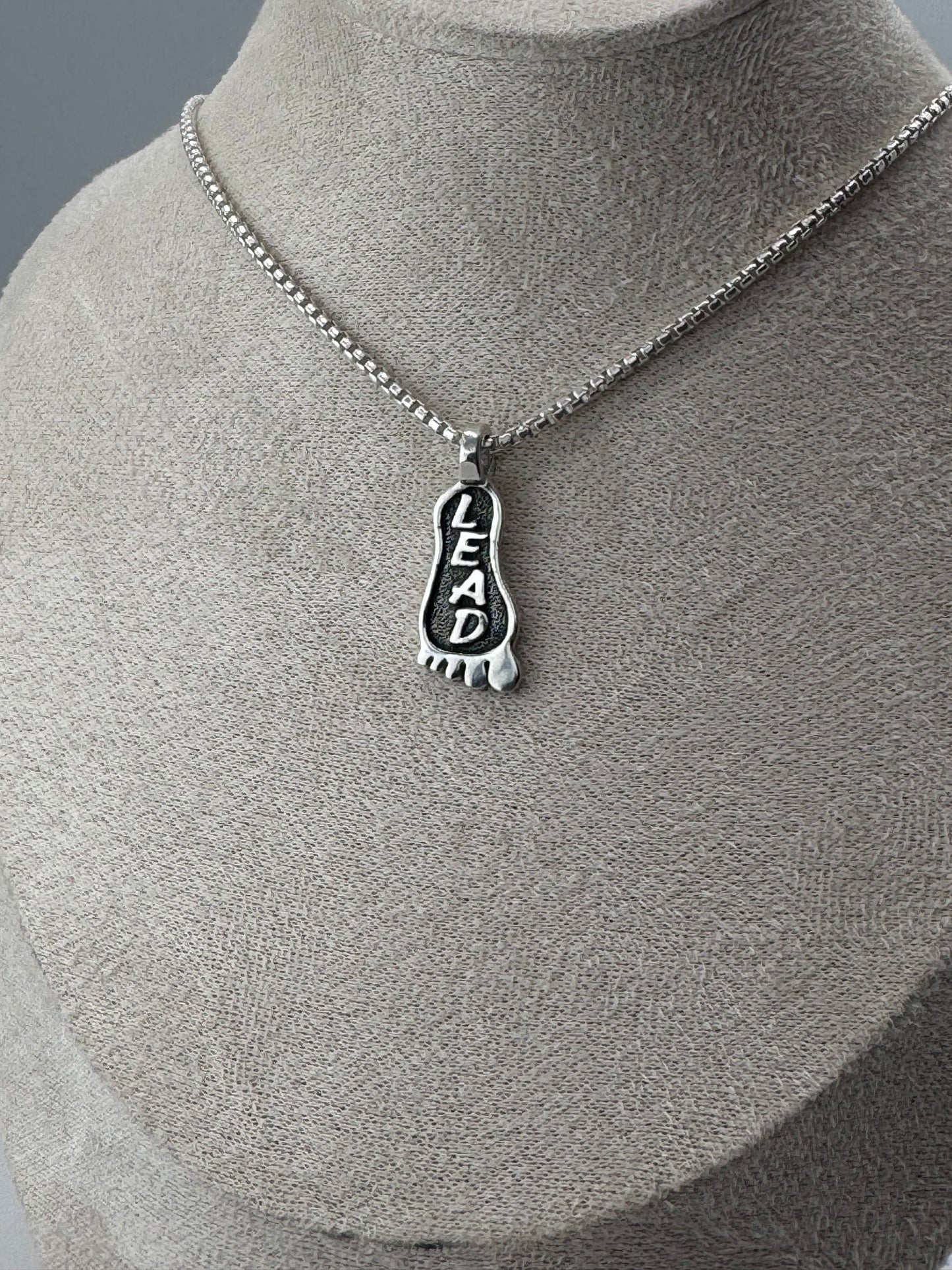 lead foot sterling silver pendant