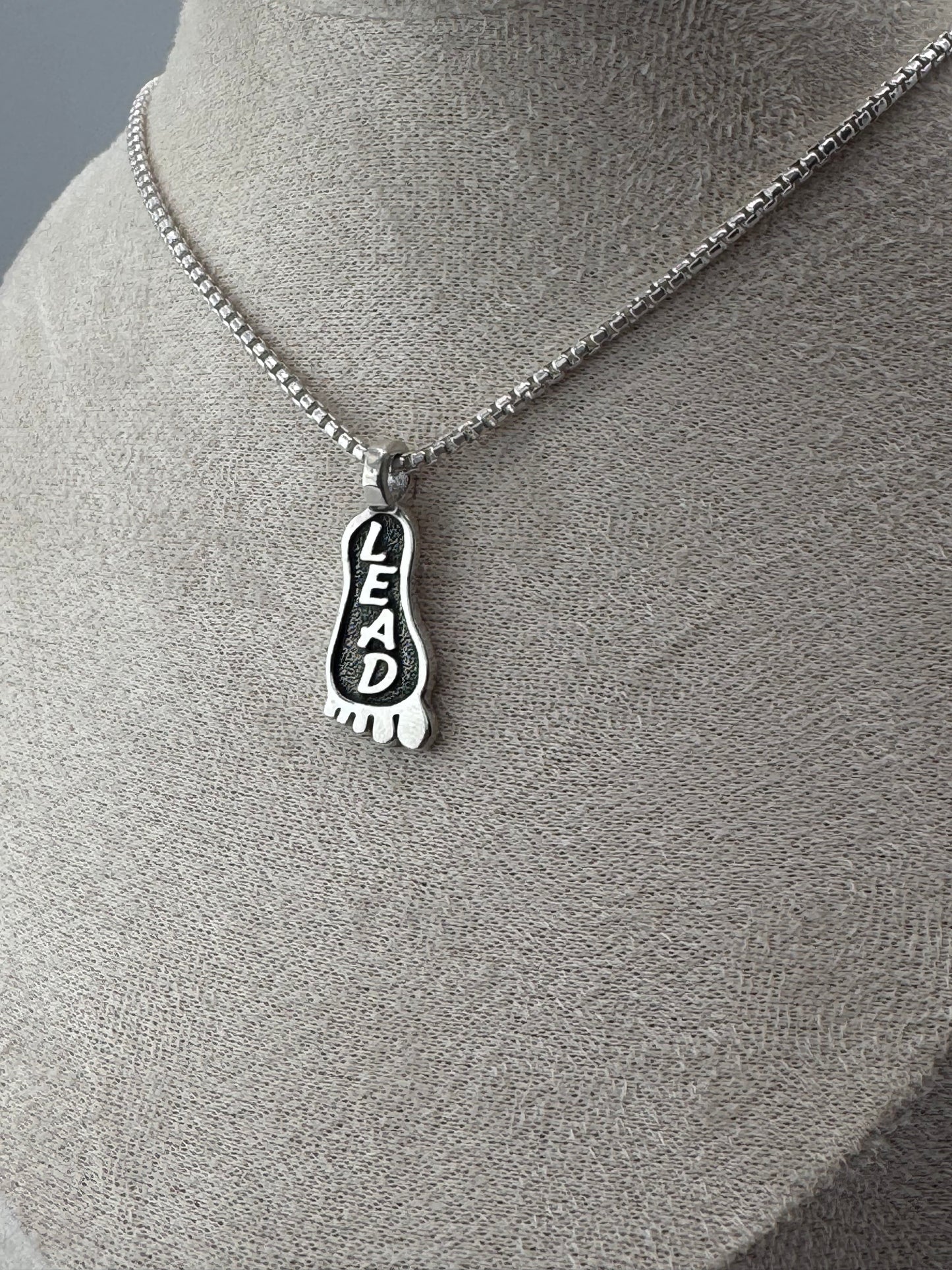 lead foot sterling silver pendant