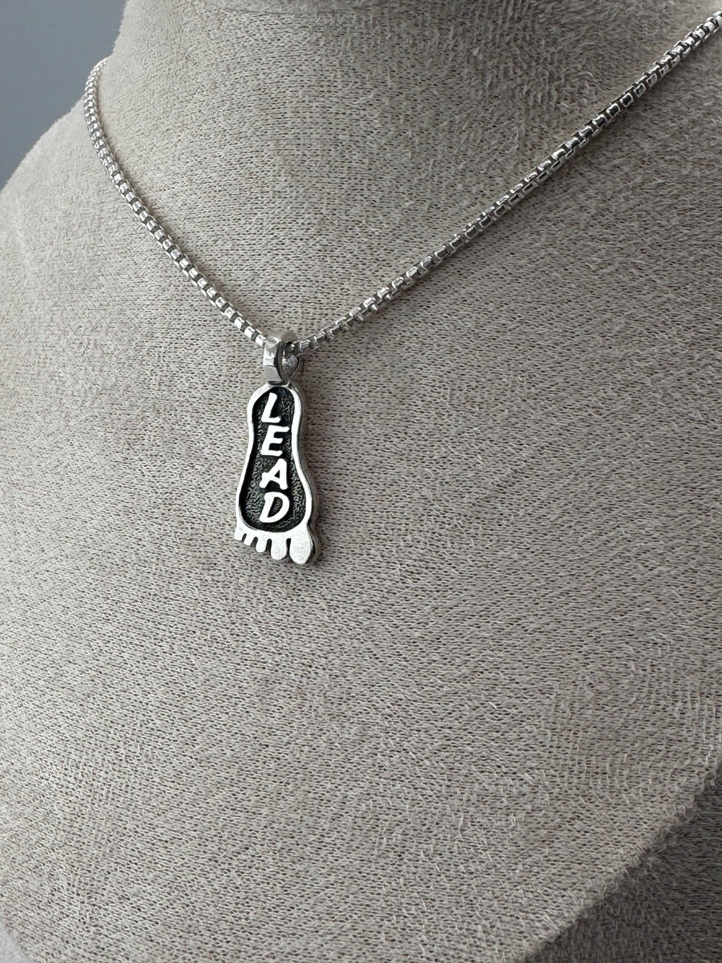 lead foot sterling silver pendant
